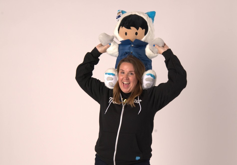 Kristi holds Astro on her shoulders like a child